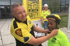 Officer Sigrist fitting a Heads Up For Safety bicycle helmet.