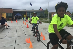 Kids participating in a bicycle safety obstacle course in Bridgeport.